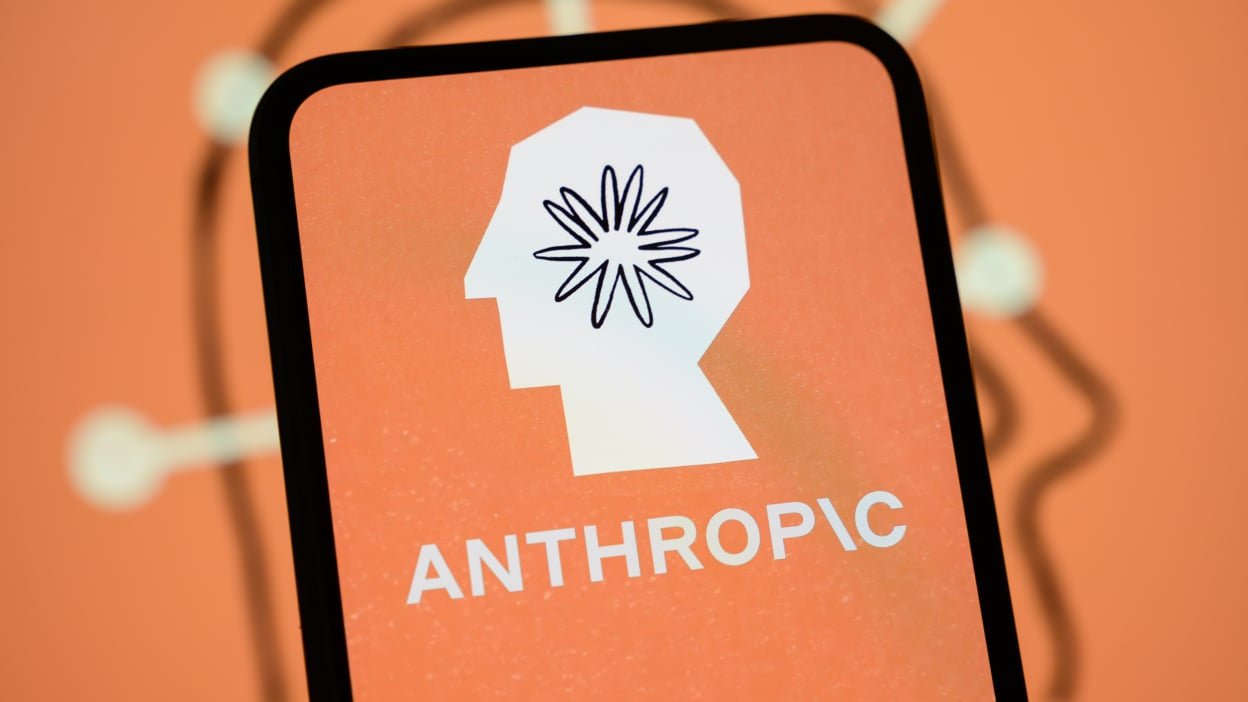 The Anthropic logo is displayed on the screen of a smartphone with the company