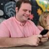 journalist alex perry looking at a smartphone